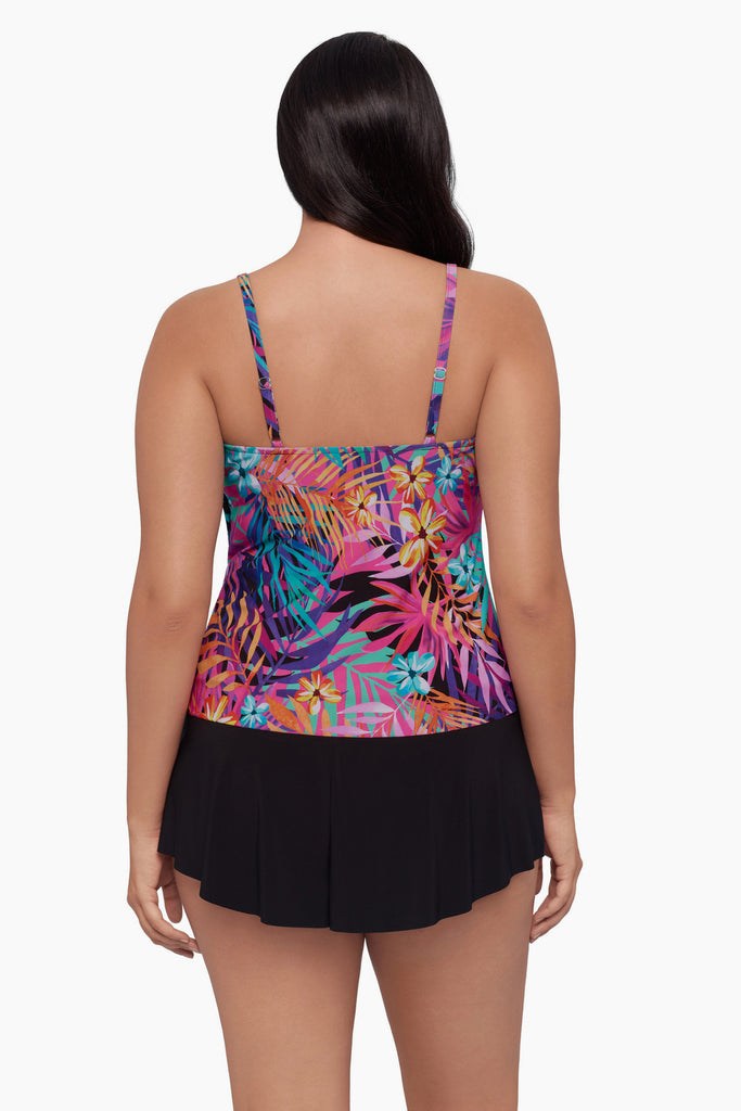 Woman turned away wearing a tankini top with a neon palm leaf print