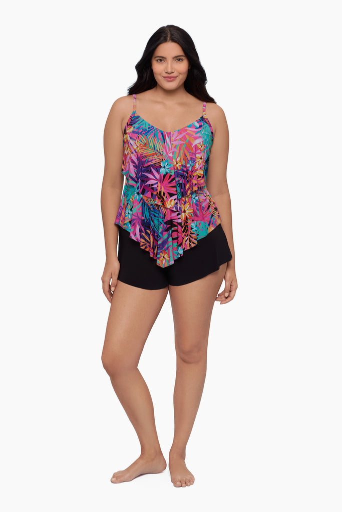 Woman wearing a tiered tankini top with a neon palm leaf print
