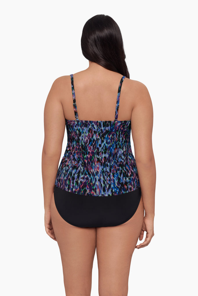 Woman turned away wearing a tankini top with a blue abstract print