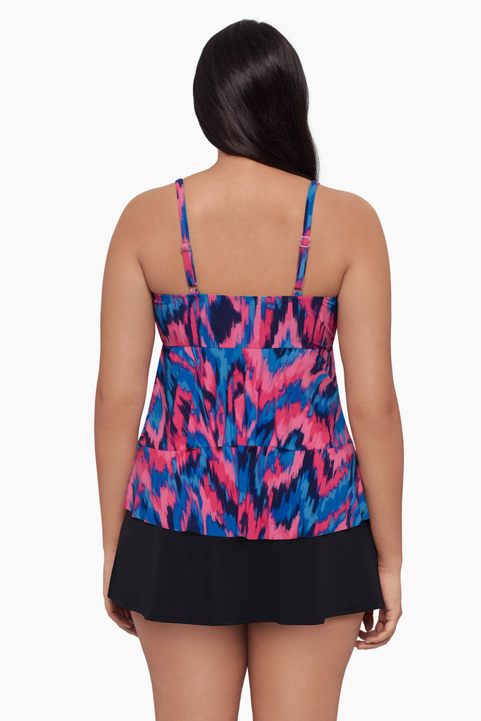 Woman turned away wearing a tankini top with a pink and blue pattern