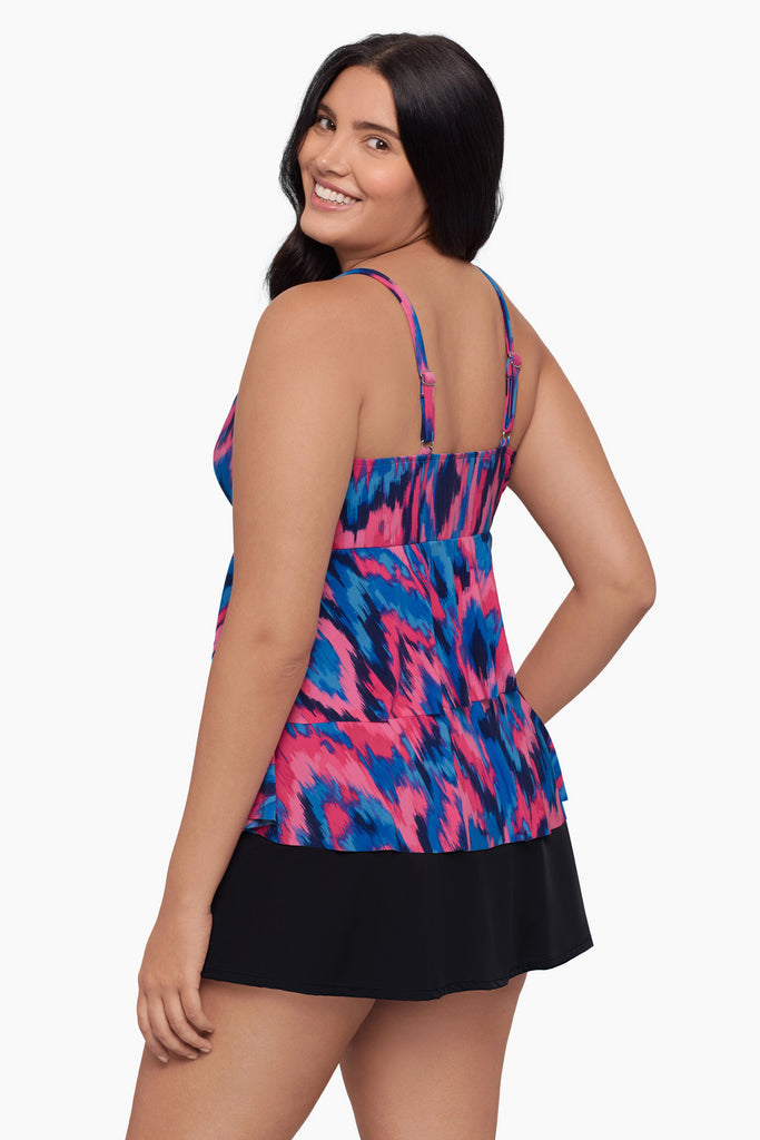 Woman turned left wearing a tankini top with a pink and blue pattern