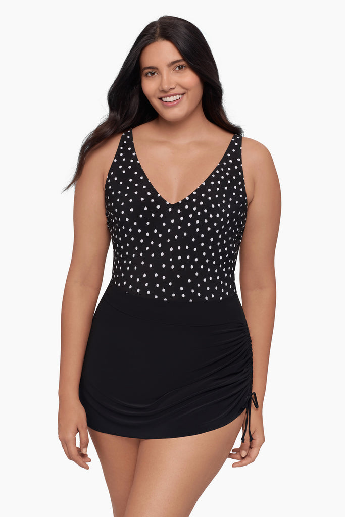 Woman wearing a swim dress with black and white polka dots