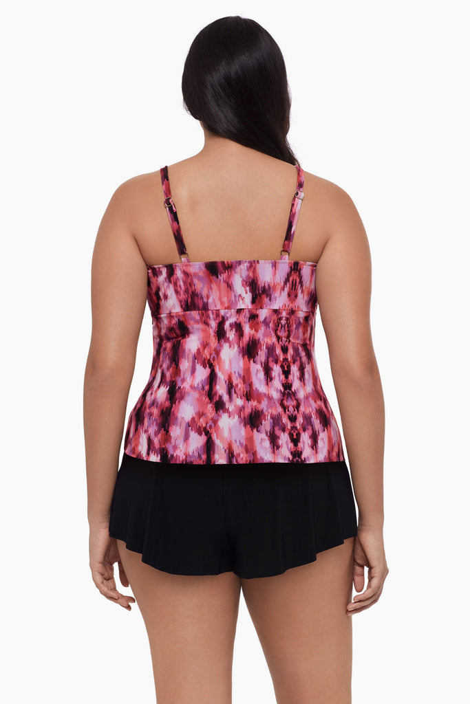 Woman turned away wearing a tankini top with an abstract pink pattern