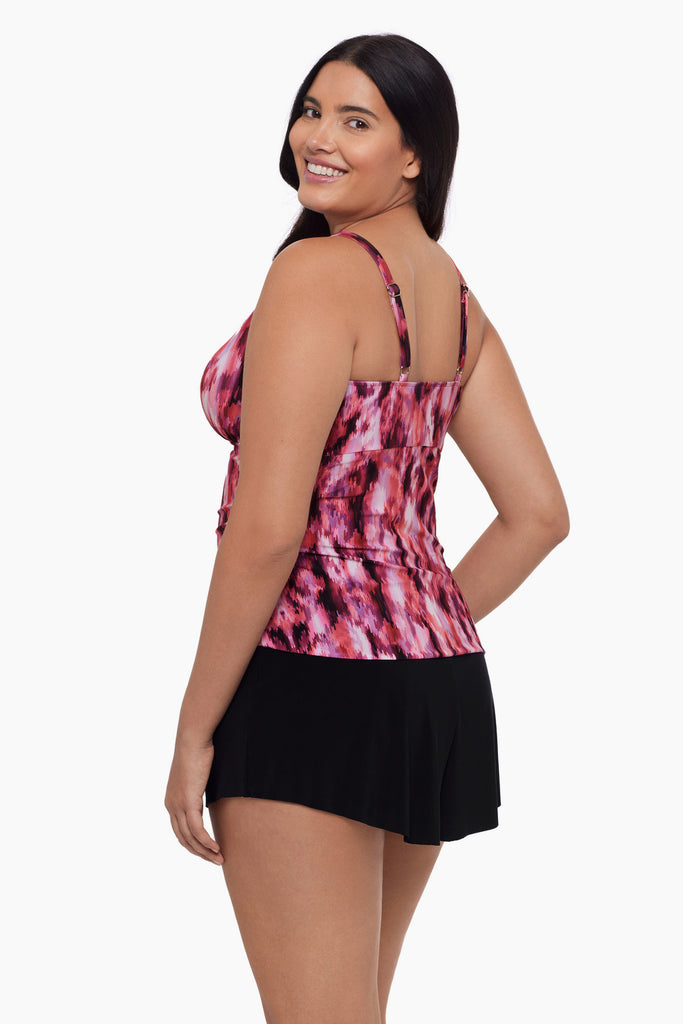 Woman turned left wearing a high neck tankini top with an abstract pink pattern