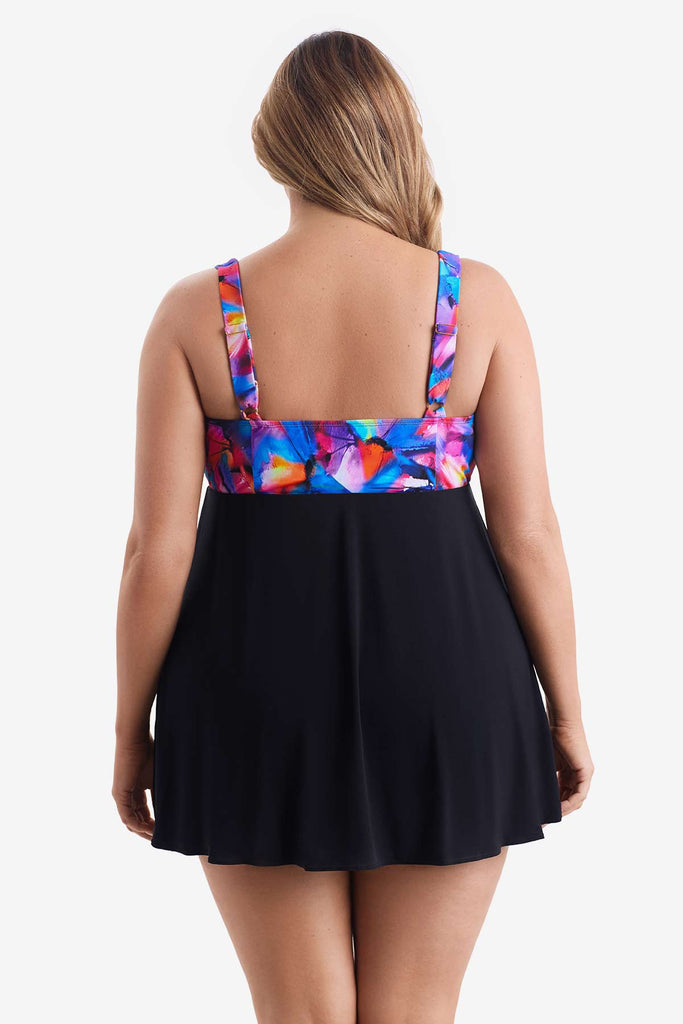 Woman turned away wearing a swim dress with a multicolored pattern on the bust