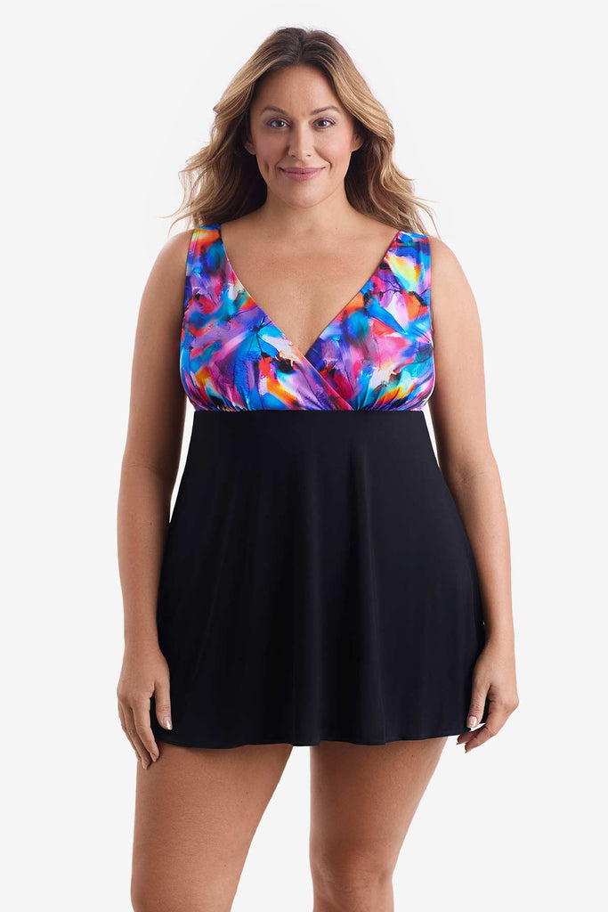 Woman wearing a swim dress with a multicolored pattern on the bust