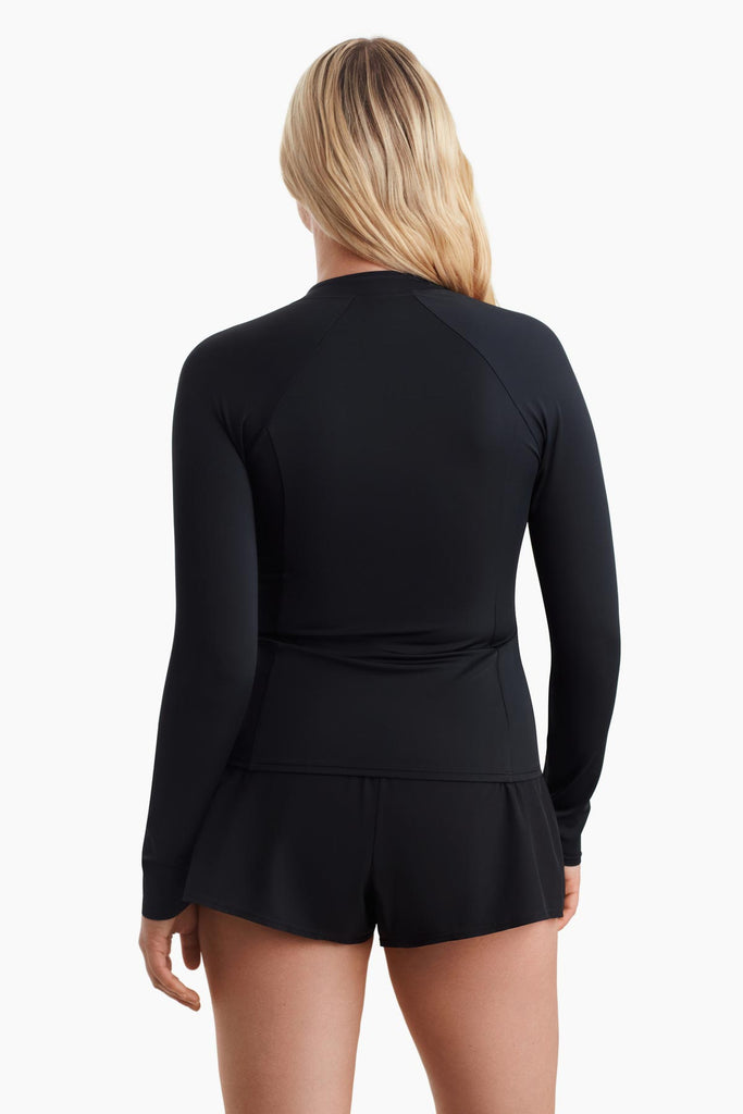 Woman facing away to show the detail on the back of the sun shirt