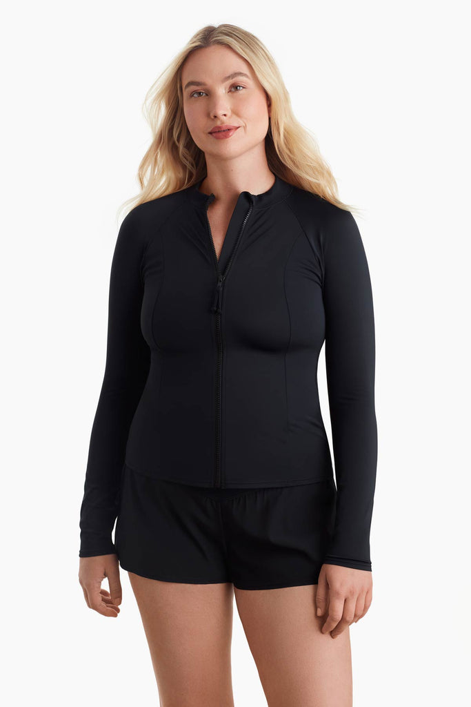 Woman wearing an all black sun shirt with a zipper in the front