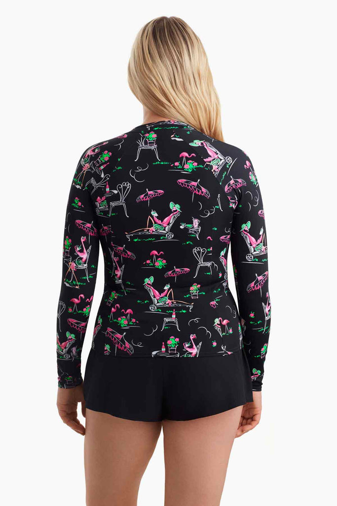 Woman faced away wearing a flamingo printed sun shirt 