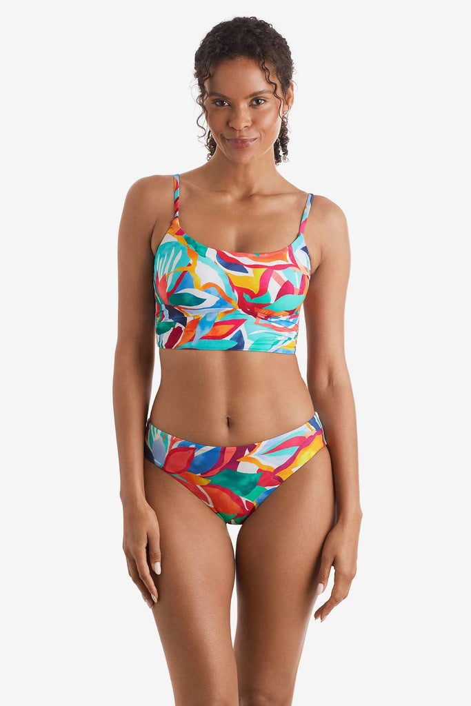 Woman wearing a multicolored floral print midkini top with matching swim bottoms