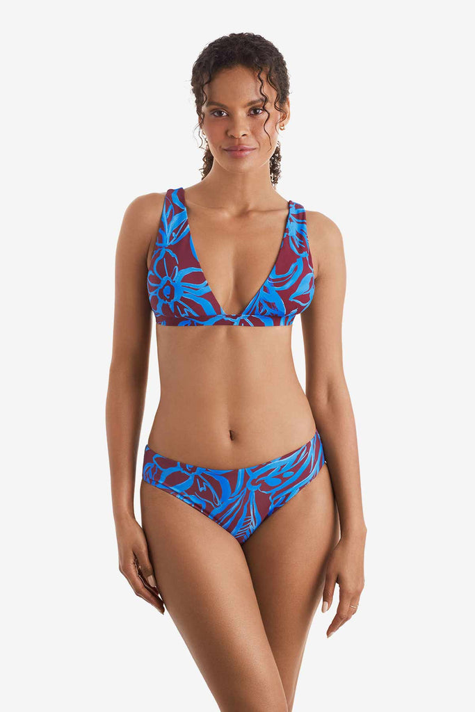 Woman wearing a blue and brown abstract printed bikini top with match swim bottoms